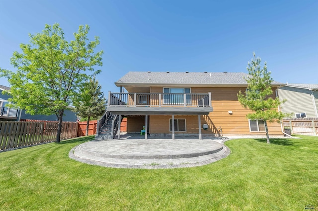 back of property featuring a lawn, a patio area, and a deck