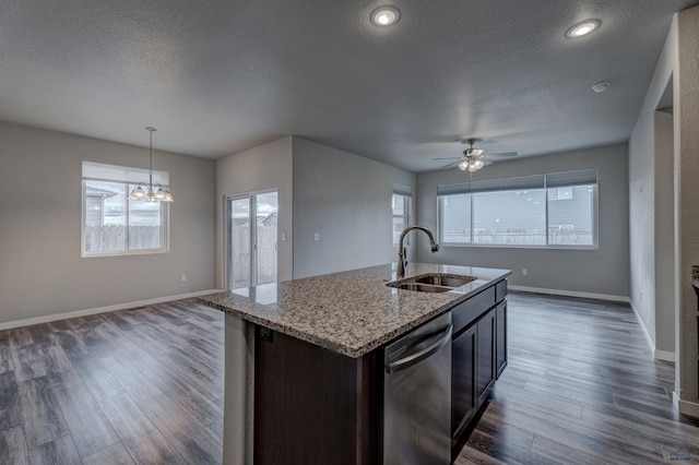 kitchen featuring pendant lighting, dishwasher, sink, a textured ceiling, and dark brown cabinets