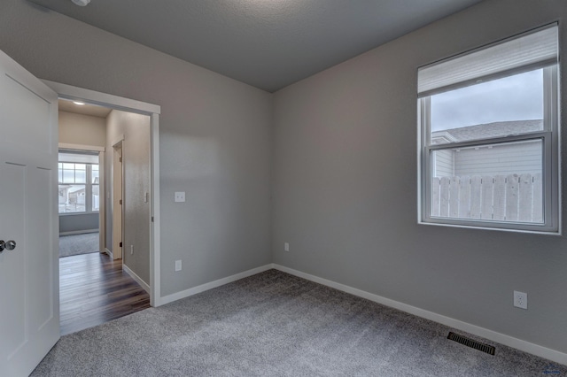 carpeted spare room with a textured ceiling