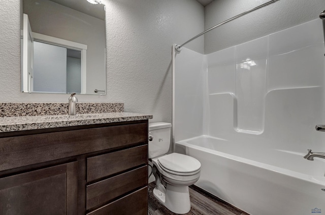 full bathroom with vanity, shower / bathtub combination, toilet, and wood-type flooring