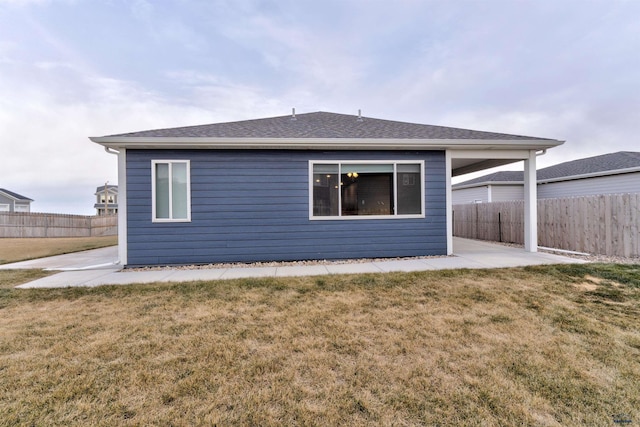 rear view of house with a lawn and a patio area