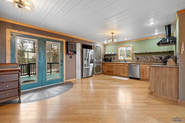 kitchen with a chandelier, appliances with stainless steel finishes, light hardwood / wood-style floors, and a wealth of natural light