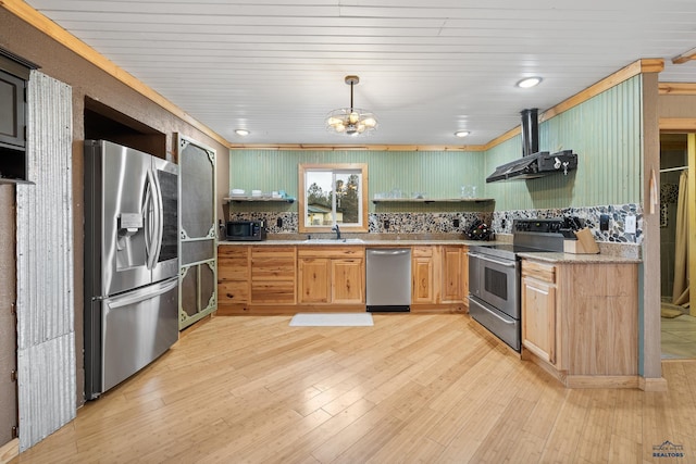 kitchen featuring appliances with stainless steel finishes, sink, exhaust hood, pendant lighting, and a notable chandelier