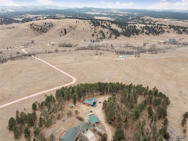 birds eye view of property with a mountain view and a rural view