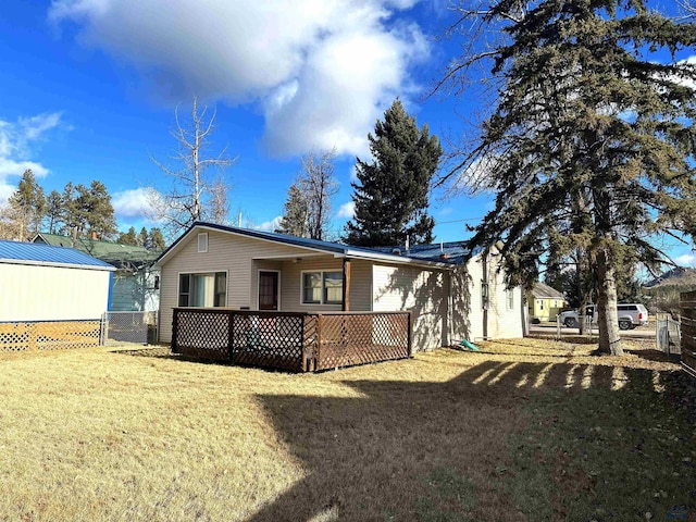 rear view of house featuring a lawn