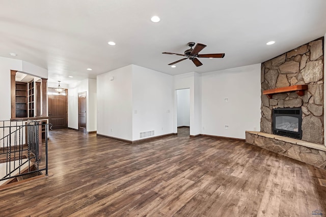 unfurnished living room with ceiling fan, dark hardwood / wood-style flooring, and a fireplace