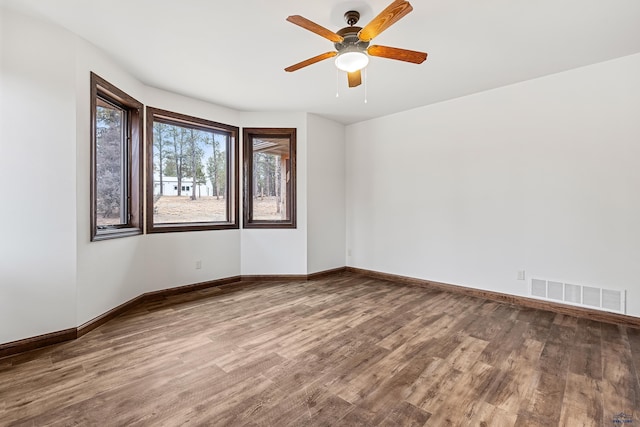 spare room featuring hardwood / wood-style floors and ceiling fan