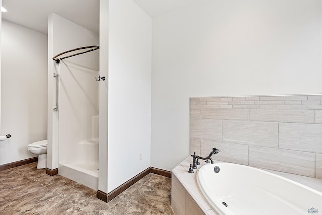 bathroom featuring toilet and independent shower and bath