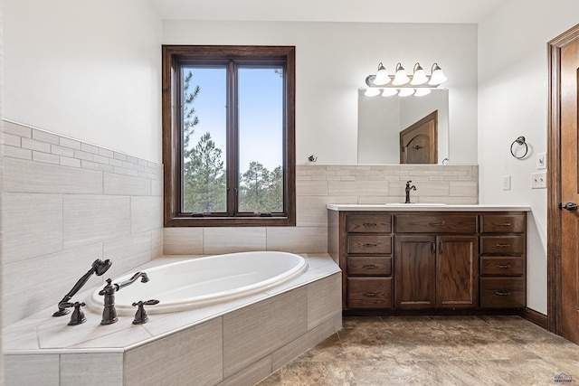 bathroom with vanity and a relaxing tiled tub