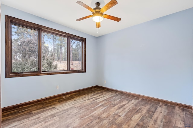 spare room featuring ceiling fan and hardwood / wood-style flooring