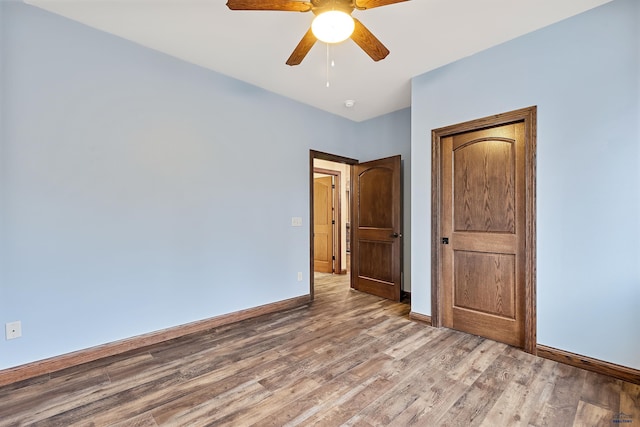 unfurnished bedroom featuring hardwood / wood-style flooring and ceiling fan