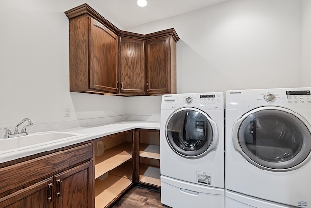 laundry room with sink, cabinets, and independent washer and dryer