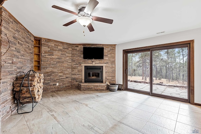 unfurnished living room featuring a fireplace and ceiling fan