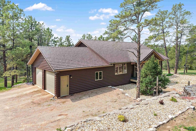 view of side of home featuring a garage