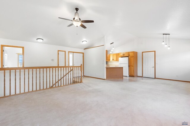 unfurnished living room with ceiling fan, lofted ceiling, and light carpet