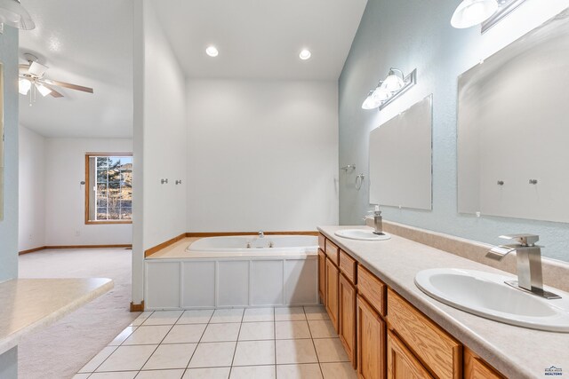 bathroom with tile patterned flooring, a bath, vanity, and ceiling fan