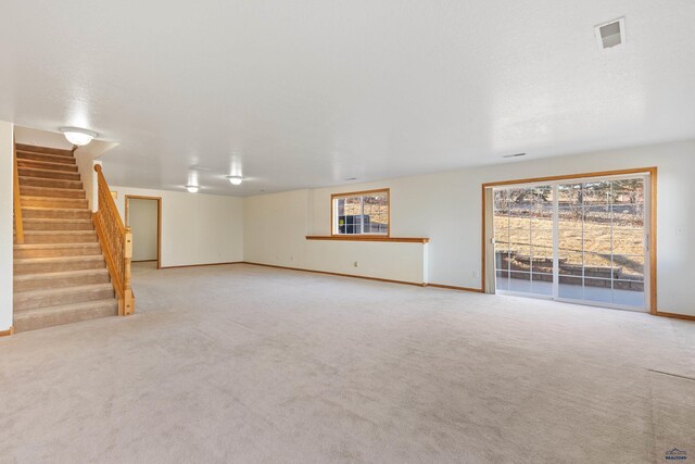 unfurnished living room with light colored carpet