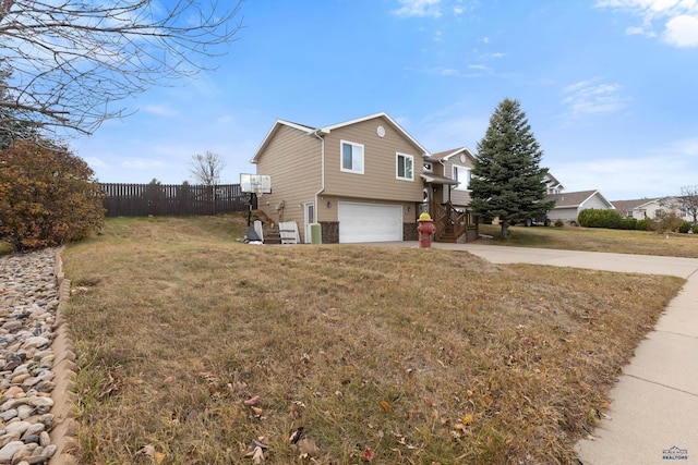 view of side of property featuring a lawn and a garage