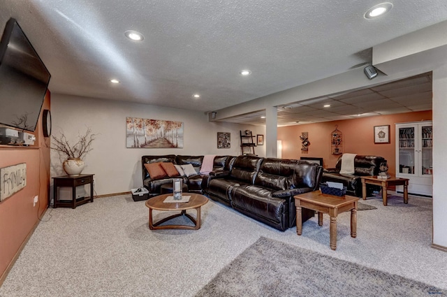 carpeted living room featuring a textured ceiling