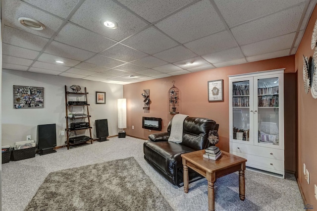 living room with carpet, a paneled ceiling, and french doors