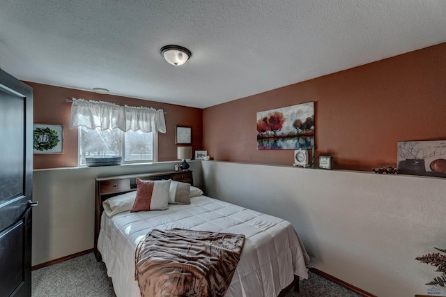 bedroom with carpet and a textured ceiling