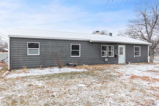 view of snow covered rear of property