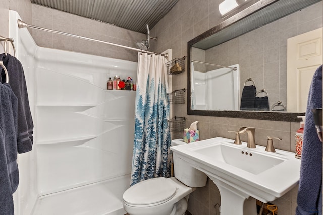210 E Montana, Rapid City, SD 57701 - full bathroom with tile walls, tasteful backsplash, toilet, a sink, and a shower stall