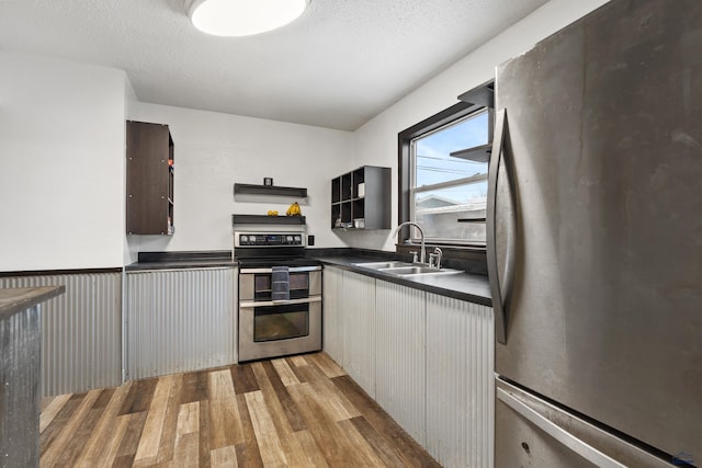 210 E Montana, Rapid City, SD 57701 - kitchen with light wood finished floors, dark countertops, appliances with stainless steel finishes, range hood, and a sink