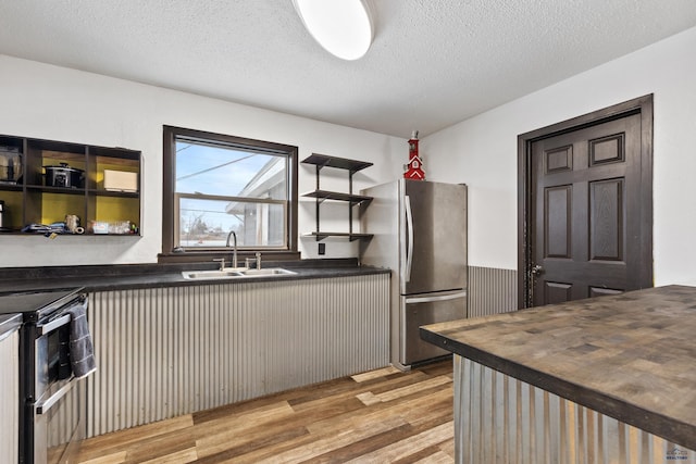 210 E Montana, Rapid City, SD 57701 - kitchen featuring stainless steel appliances, a sink, wood counters, light wood-style floors, and open shelves