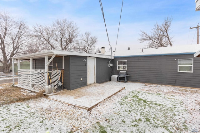 210 E Montana, Rapid City, SD 57701 - snow covered rear of property featuring a patio area and a chimney
