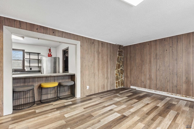 210 E Montana, Rapid City, SD 57701 - spare room with a textured ceiling, wood finished floors, and wooden walls