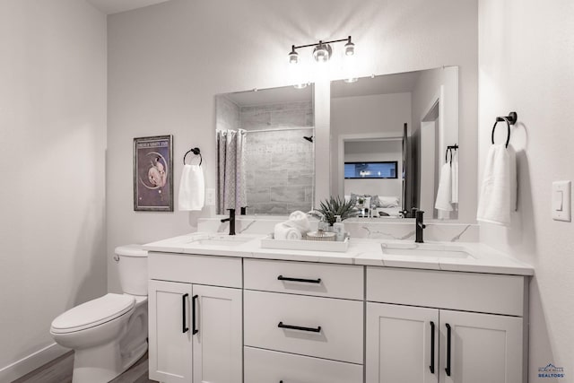 bathroom with toilet, vanity, hardwood / wood-style floors, and walk in shower