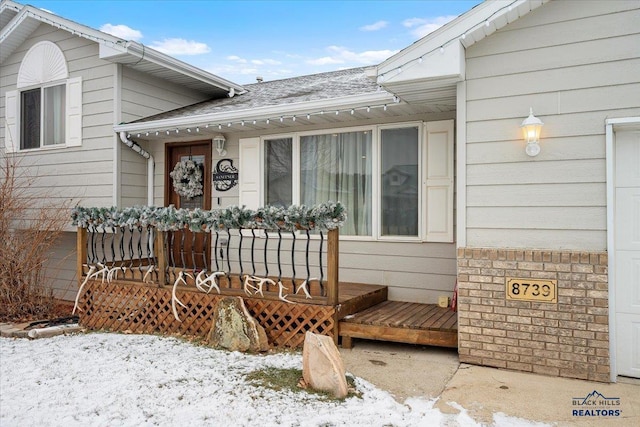 view of snow covered property entrance