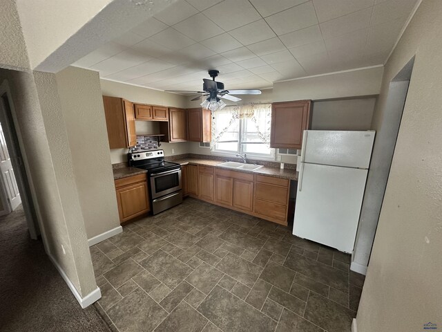 kitchen featuring white fridge, stainless steel electric range oven, ceiling fan, and sink