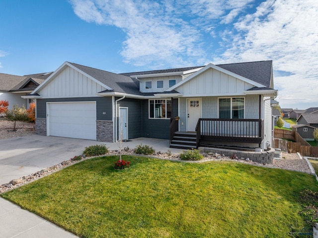 view of front of home featuring covered porch, a front yard, and a garage