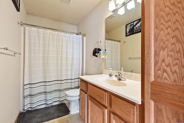 bathroom with tile patterned floors, vanity, and toilet