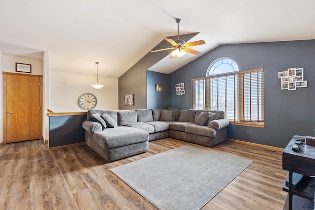 living room with wood-type flooring, vaulted ceiling, and ceiling fan