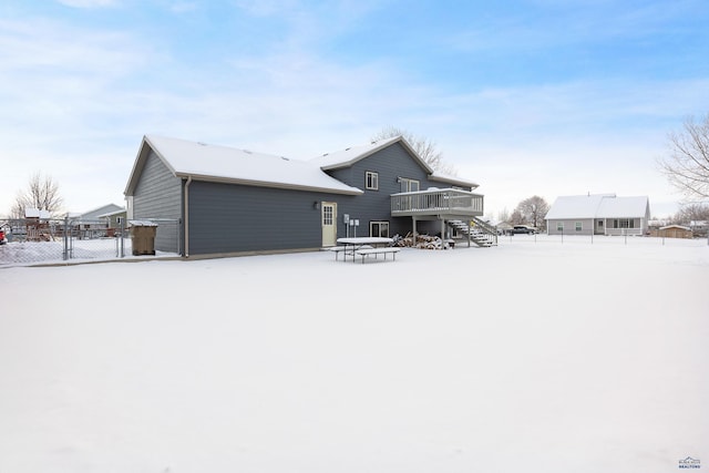 snow covered property featuring a deck