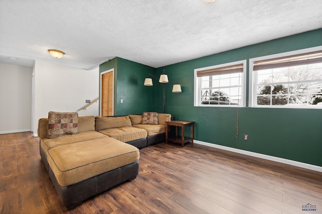 living room featuring a textured ceiling and dark hardwood / wood-style floors