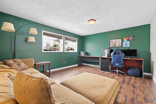 home office featuring hardwood / wood-style floors and a textured ceiling