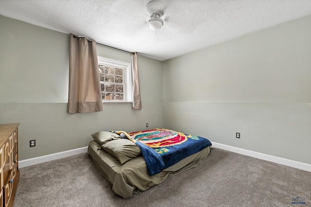 carpeted bedroom featuring a textured ceiling and ceiling fan