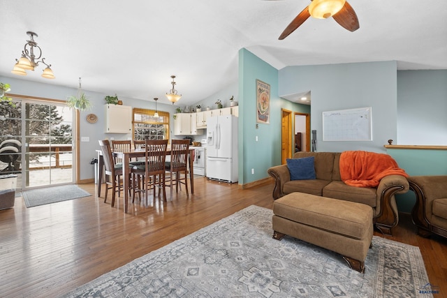 living room featuring hardwood / wood-style flooring, ceiling fan, and lofted ceiling