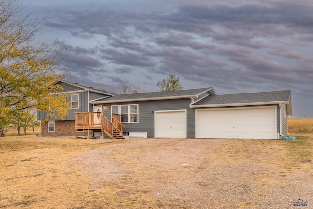 view of front of property with a garage and a wooden deck