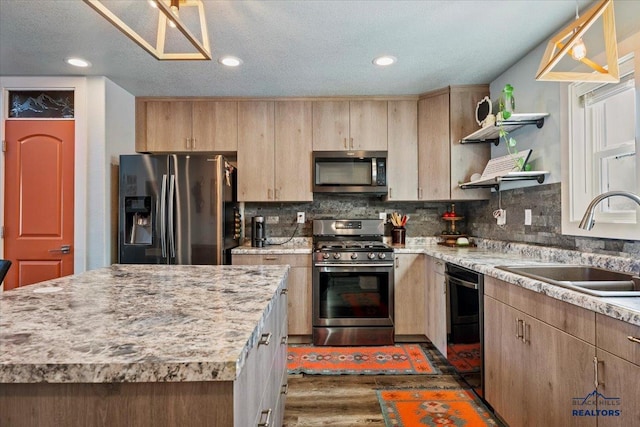 kitchen featuring sink, stainless steel appliances, dark wood-type flooring, light brown cabinetry, and a kitchen island