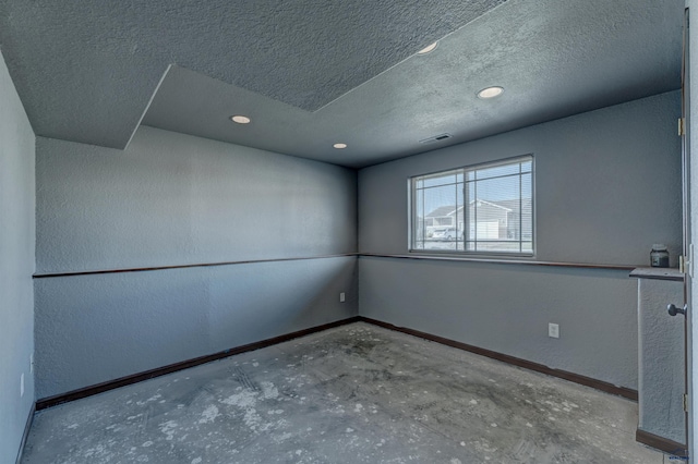 spare room with concrete flooring and a textured ceiling