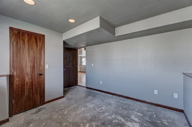 unfurnished bedroom featuring a textured ceiling and a closet