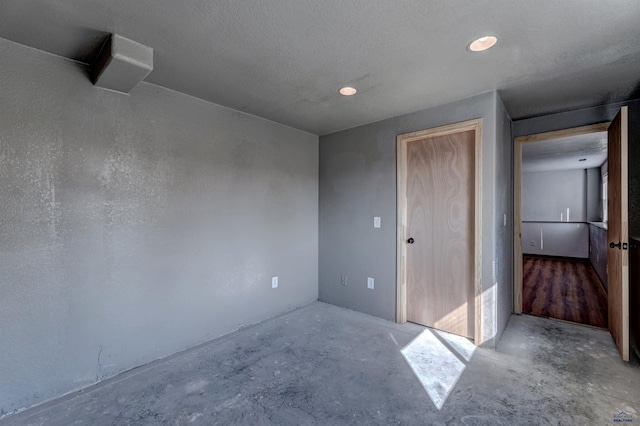 unfurnished room with concrete flooring