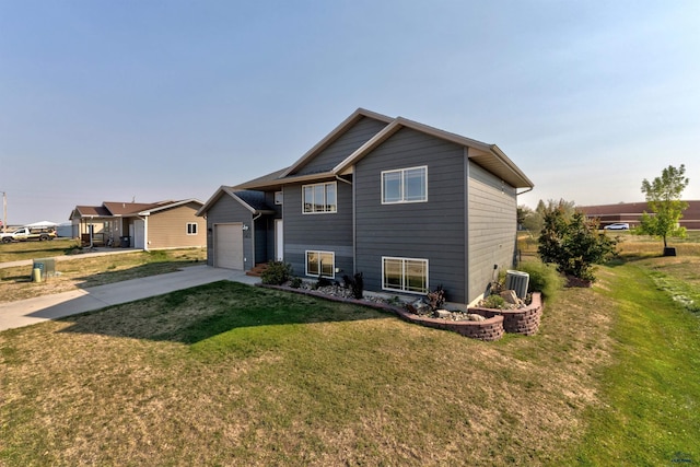 rear view of house with a lawn and a garage