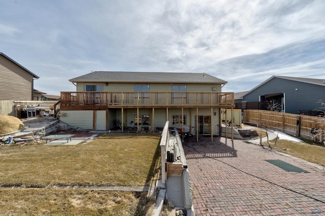 back of property with a yard and a patio area