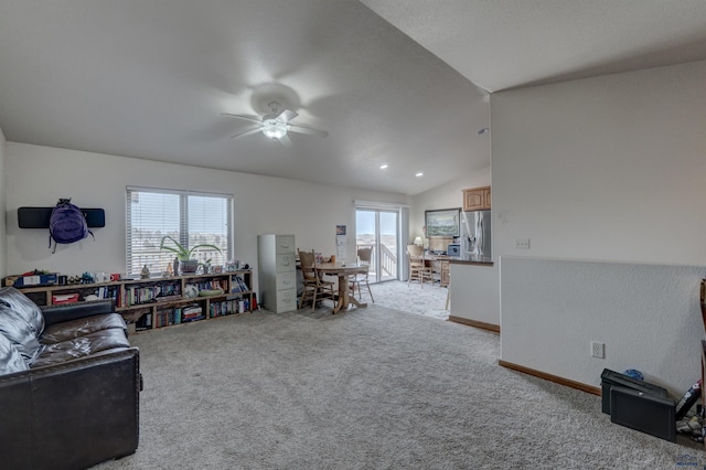 living room with plenty of natural light, ceiling fan, lofted ceiling, and light carpet